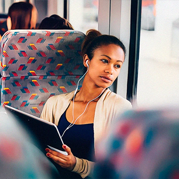 a woman looks out from window in a bus